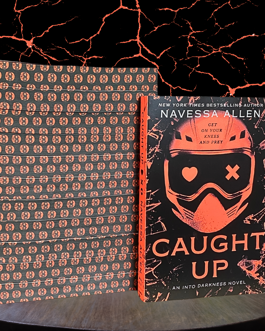 Book titled 'Caught Up' by Navessa Allen with a patterned cover on a dark background